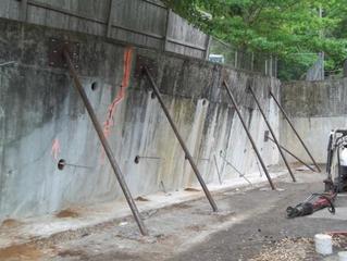 Bottom row of helical tiebacks being installed around bracing