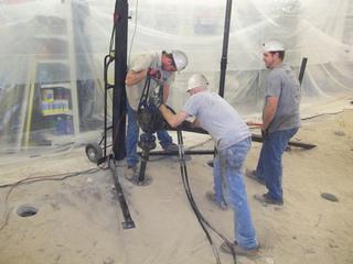 Advancing helical pier with handheld equipment