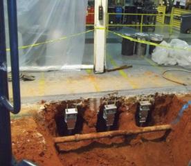 Retrofit helical piers installed to support column footings