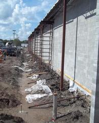 Lateral bracing anchored to new footing