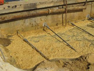 Helical tiebacks with threaded rod extending
through seawall; prior to pre-tensioning