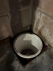 Progress image showing the excavated area for the sump pump basin.