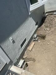 Progress image showing some additional push piers that have been installed prior to being completely backfilled and hidden.