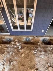 View of the helical piers installed beneath the deck section.