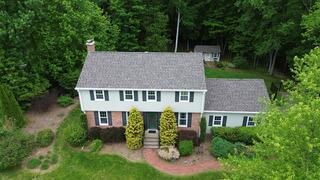 This photo highlights the completed roof featuring IKO Dynasty shingles in the color Driftshake. Not only do these shingles give the home a clean, refreshed look, but they're also built to perform. IKO Dynasty shingles are designed with ArmourZone technology for added nail-holding strength and wind resistance, perfect for standing up to tough Northeast weather. With algae-resistant granules and a wide nailing area for secure installation, this roof is more than just beautiful. It's a durable, long-lasting investment in the home's protection.