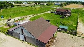 Overview of the finished hybrid roofing system on a working horse farm, featuring clean installation and rural Delaware scenery.