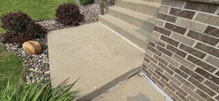 Before: The slabs in front of the step have begun sinking causing a large step-up height in the area