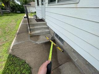 Before: The sidewalk around the steps have begun sinking causing the area to become bumpy and uneven.