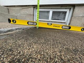 A close-up of the bump that had started forming where the step and sidewalk meet.