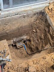 This is one of the high-strength steel Push Piers, driven deep into the ground to provide lasting stability and lift for a settling foundation.
