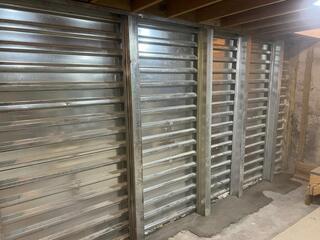 This photo showcases the completed EverBrace system. The homeowner chose to leave the reinforced panels as they were, but if anyone is not a fan of this look and prefers something more finished looking, we can also cover the EverBrace with DryWall!