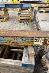 Cribbing and beam tracks placed above helical piers