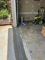 To stop surface water from entering through vulnerable areas like doorways and stairwells, we installed our TrenchDrain system. Its grated design captures water at ground level and channels it directly into the drainage system.