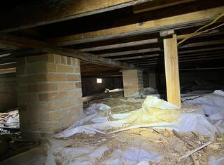 The original vapor barrier had been moved around, crumpled, torn, and left plenty of exposed areas for moisture to come through.