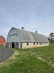 Now, Mary was ready to replace her last structure, the barn. This before shot shows just how badly the barn needed a new roof. Shingles were missing across the surface, and you can clearly see the streaks from years of weather damage. After every storm, shingles would end up scattered on the ground, and it was time for a long-lasting solution.