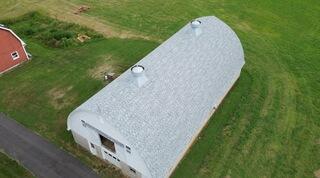 The barn is now complete with IKO metal shingles in Frostone Grey, and it looks better than ever. Each shingle was hand-sealed due to the steep slope, giving it extra protection against wind and weather. These shingles also contain built-in algae-resistant granules to help prevent the streaking and discoloration that the old roof suffered from. With a clean finish and a spotless job site, this barn is ready to stand strong for years to come.