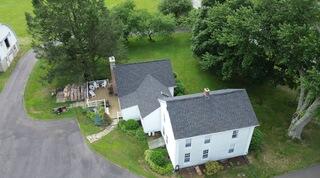 Five years later and Mary's home roof still looks as good as new! After a leak through her bathroom vent, she trusted us to replace her roof with a full Klaus Roofing System in Granite Black, and she hasn't had a single issue since. So when it came time to replace the roofs on her barns, she knew exactly what to do.