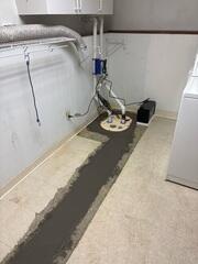 Our crew installed the sump pump at the corner of the room