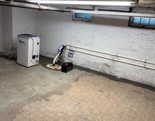 The WaterGuard drainage system is installed along the perimeter of the basement floor and covered in fresh concrete. The SaniDry XP keeps humidity in the basement low and drains itself into the TripleSafe sump pump. The TripleSafe sends all of the water out of the basement through the discharge lines.