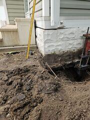 During: Our Foreman, Juan, and his crew secured Helical Piers below the sinking home.