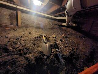 Crawl space before waterproofing: damp, musty, and unprotected from moisture intrusion.