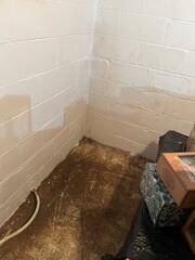 Water stains can be seen along the edges of the floor