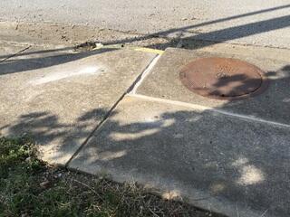 Spot 4 - After Photo: We raised the two slabs adjacent to the manhole cover by a couple inches to level everything back out.