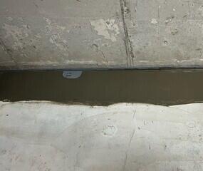 WaterGuard is installed along the perimeter of the floor and covered in fresh concrete to provide a seamless finished look. The WaterGuard Port is left visible to provide access to the system when needed.