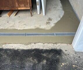 TrenchDrain XL was installed on the inside of the garage door to catch excess and surface water. It is connected to the WaterGuard drainage system.