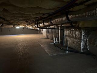 The crawl space was damp, dark, and unprotected, allowing moisture and humidity to rise into the home.