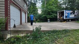 This photo shows just how level the driveway was when we finished. It also shows the void we filled with our foam on the hillside. The void filling process makes sure critters can't burrow underneath the driveway, and it further contains the soil from washing away.