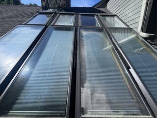 This section of the roof had eight skylights installed side by side, which created a lot of problems over time. With so many skylights crammed into one area, the gutters between them were too narrow to handle water flow. Leaves and debris would collect quickly, causing constant clogs and putting the roof at risk of leaks. The homeowner was stuck with the hassle of frequent upkeep just to keep water moving properly.
