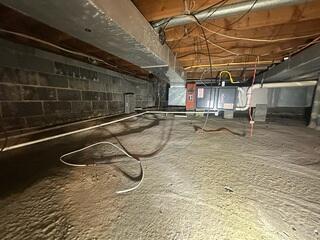 This concrete crawl space in Interlaken, NJ was damp, humid, and showing signs of sagging floors above.
