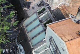 Here's the start of the transformation. Our crew began removing shingles around the section with eight skylights, preparing to take on the toughest part of this project.