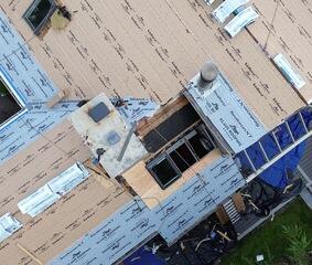 This shot shows the major change. The cluster of eight skylights has been reduced to just three, and the top row is about to be closed in with fresh plywood. This gave the homeowner more roof space and less maintenance to worry about.