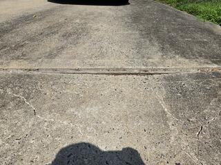 Over time, rainwater and moisture seeped through cracks and joints, washing away the supporting soil and creating voids, causing the concrete to sink and shift unevenly.