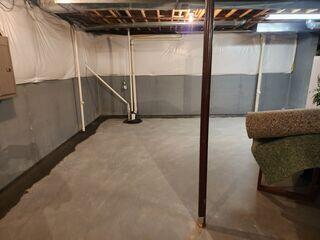 This photo was taken by our foreman after the job was completed. You can see that our WaterGuard drains are tied into all of the radon suction points, including the two pipes running straight out of the floor slab and into the ceiling.