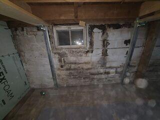 Repairing a tilted basement wall with PowerBrace in Saint-Alexis-Des-Monts,...