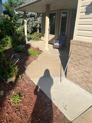 Before: The slabs had begun sinking along the walkway and porch