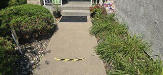 Before: The slabs in front of the homeowners step had begun settling