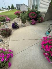The walkway of the home where a crack can be seen