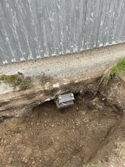 During: Our Foreman, Aaron, and his crew successfully secured seven Helical Piers along the shed foundation.