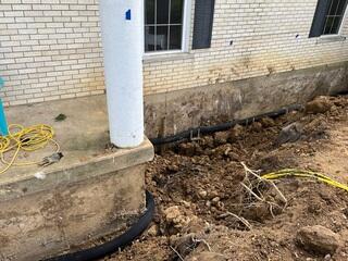 In this photo you can see the exterior French drain, which we carefully worked around during excavation to avoid any damage.