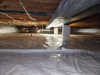 Underneath the vapor barrier on the floor in this crawl space is our Terrablock floor insulation. Its puncture-resistant, and durable enough for access. It also makes the crawl space super comfortable to crawl across. It has an R-3.2 insulation rating.