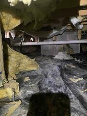 This is what the crawl space looked like before we repaired it. Fiberglass was drooping from the ceiling, moisture was running rampant, and the floors above the space were very cold in the winter.