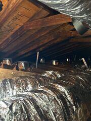 These are the flex ducts that replaced all the panning. They are one piece and are sealed at the ends so there's no leakage to the attic. They are insulated under the foil jacket to reduce heat loss. The foil jacket helps reflect heat back into the attic in the summertime. These will also be partially buried in the cellulose insulation to be added.