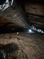 After all that work is done down at ceiling level, the cellulose insulation is blown-in. The top of one of the red/white rulers is just visible left of center.