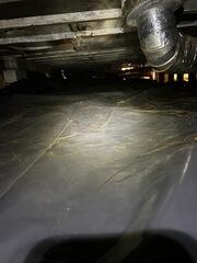 After removing 9 cubic yards of dirt from the space, we installed our 6 mil vapor barrier to prevent moisture from making its way up through the floor.