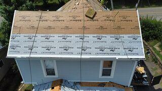 Our white colored KRS Ice & Water shield membrane was adhered to the most vulnerable spots of the roof. More specifically - six feet up from all edges, in the valleys, and all over the lower sloped front and back porch roofs. This shield is adhered with its gluey substance backing, which helps create a waterproof seal over the galvanized nails we installed over the top of it.