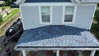 This photo shows the new rubber liner we installed in the box gutter. The EPDM reaches 18 inches up under the shingles, and we installed termination bars at the eaves and rakes.